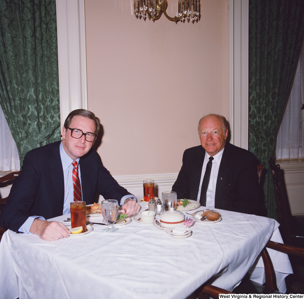 ["Senator John D. (Jay) Rockefeller and an unidentified individual dine together."]%