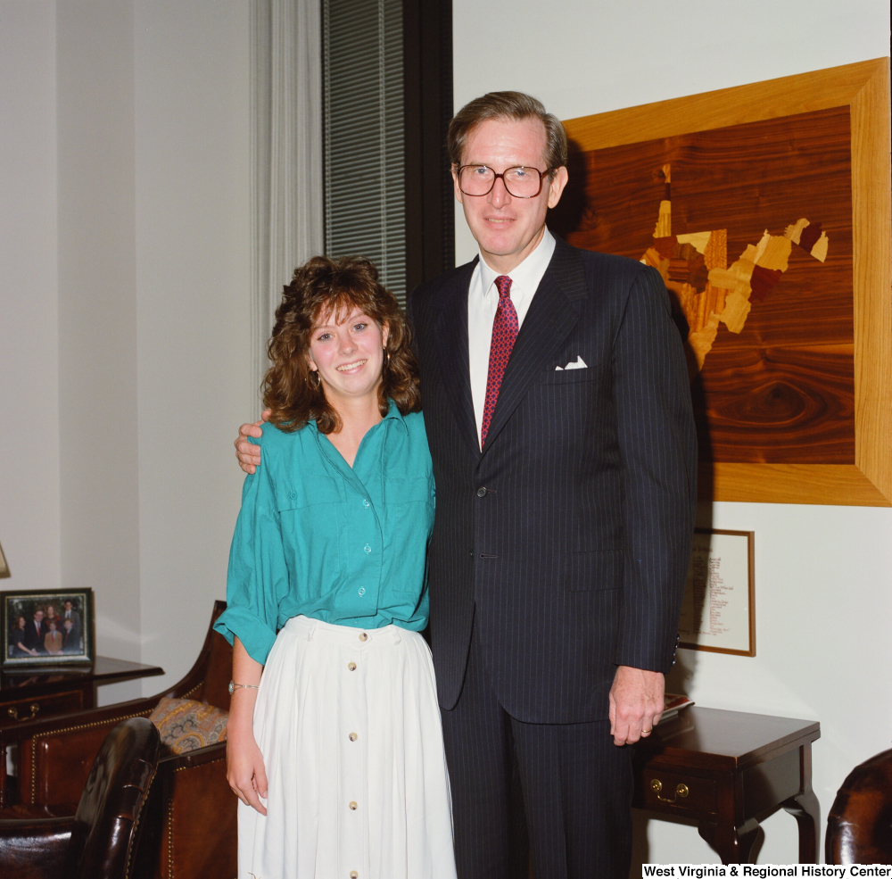 ["Senator John D. (Jay) Rockefeller and an unidentified young woman in his Washington office."]%