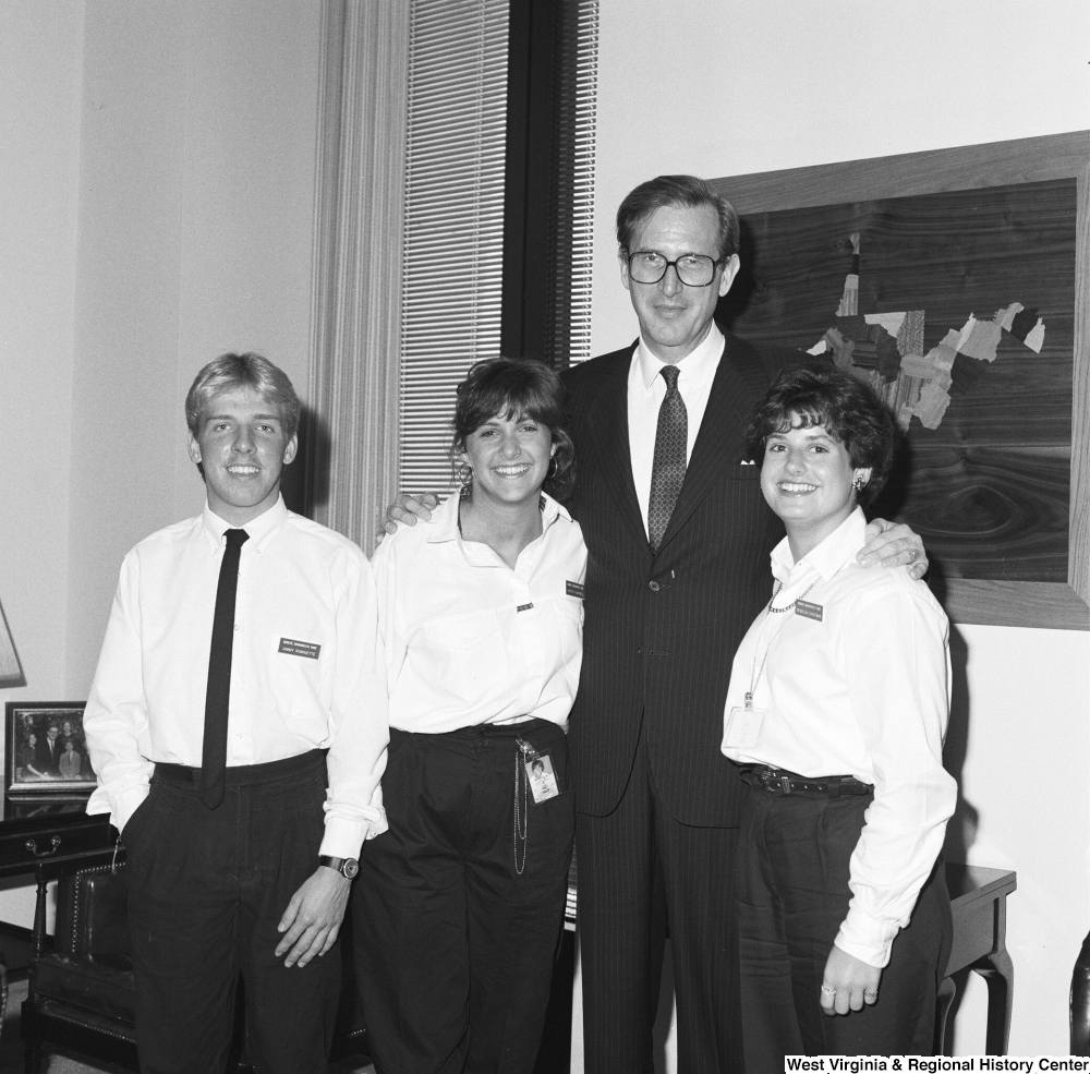 ["Senator John D. (Jay) Rockefeller stands in his office with three Senate Democratic Pages."]%