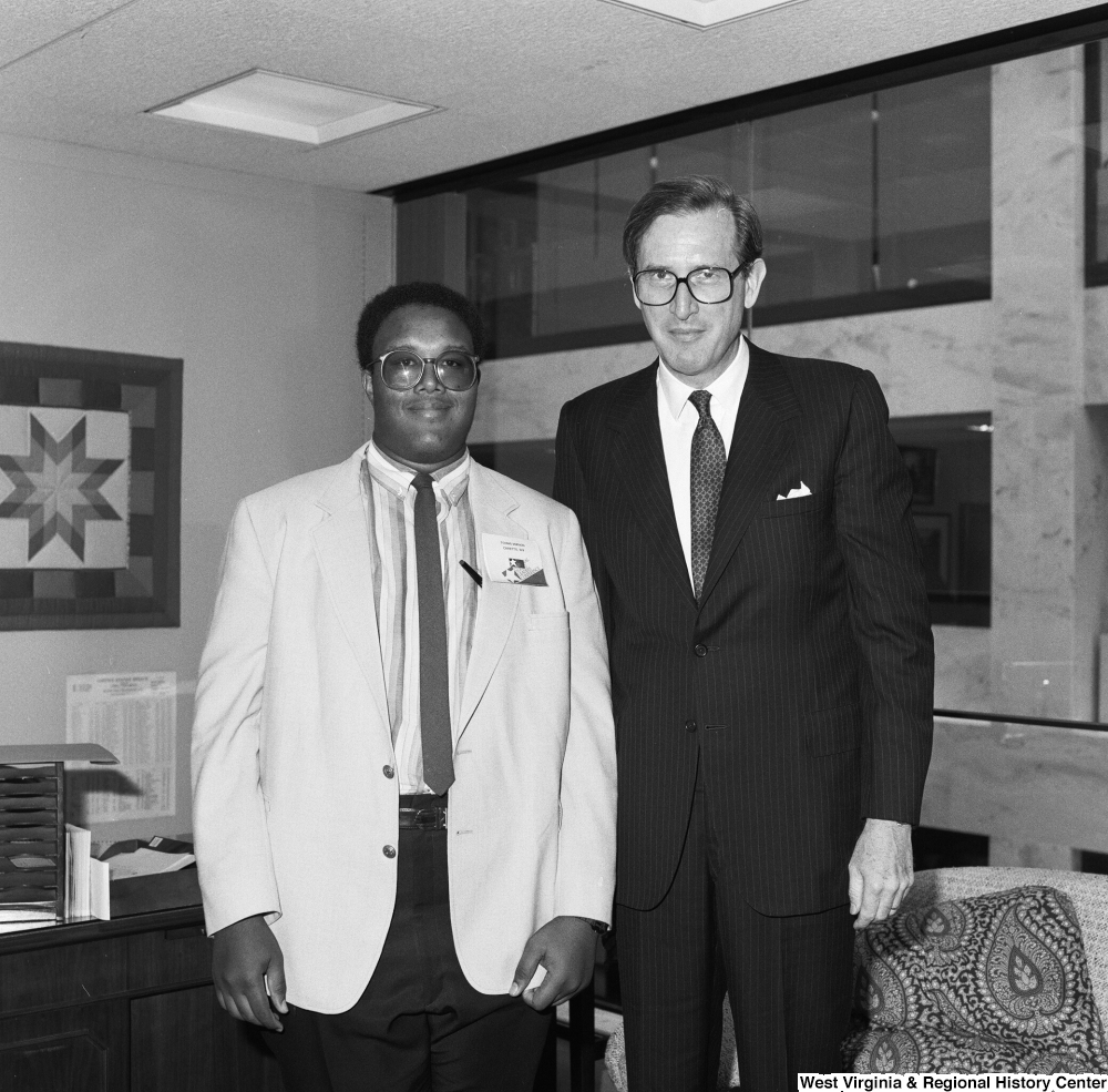 ["Senator John D. (Jay) Rockefeller stands in his office with a participant in the National Young Leaders Conference."]%