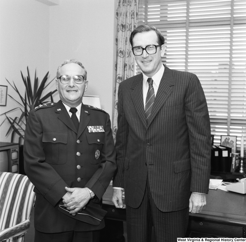 ["Senator John D. (Jay) Rockefeller stands with an unidentified military officer in his office."]%