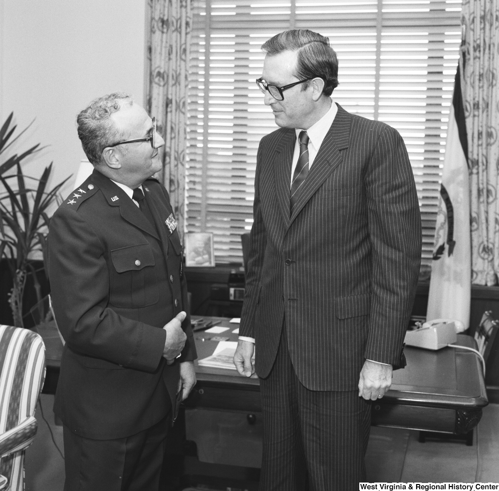 ["Senator John D. (Jay) Rockefeller speaks with an unidentified military officer in his Washington office."]%