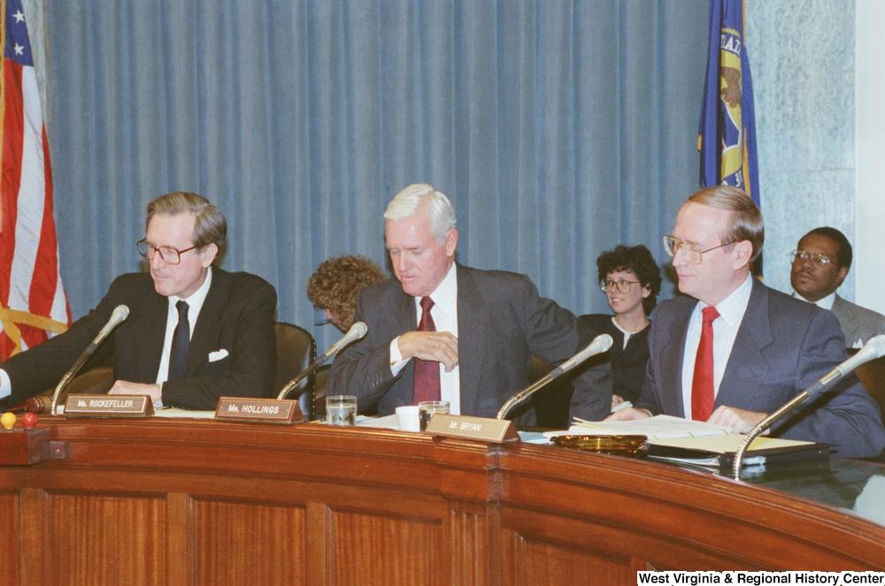 ["Senator John D. (Jay) Rockefeller sits with two other Senators at a Commerce Committee hearing."]%