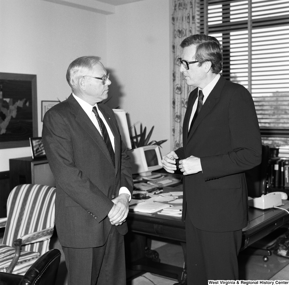 ["Senator John D. (Jay) Rockefeller speaks with an official from General Electric."]%