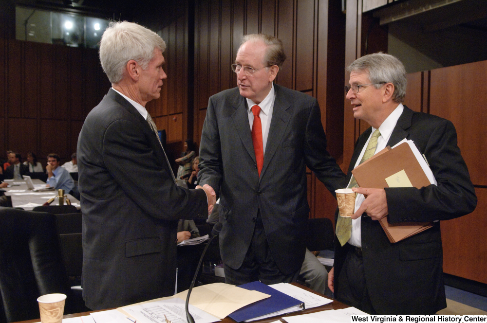 ["Senator John D. (Jay) Rockefeller shakes hands with two unidentified men at an executive session of the Finance Committee."]%