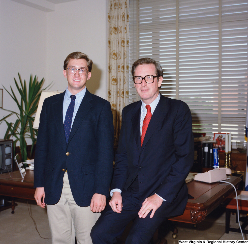 ["In this color photograph, Senator John D. (Jay) Rockefeller poses for a photograph in his office with an unidentified young man."]%