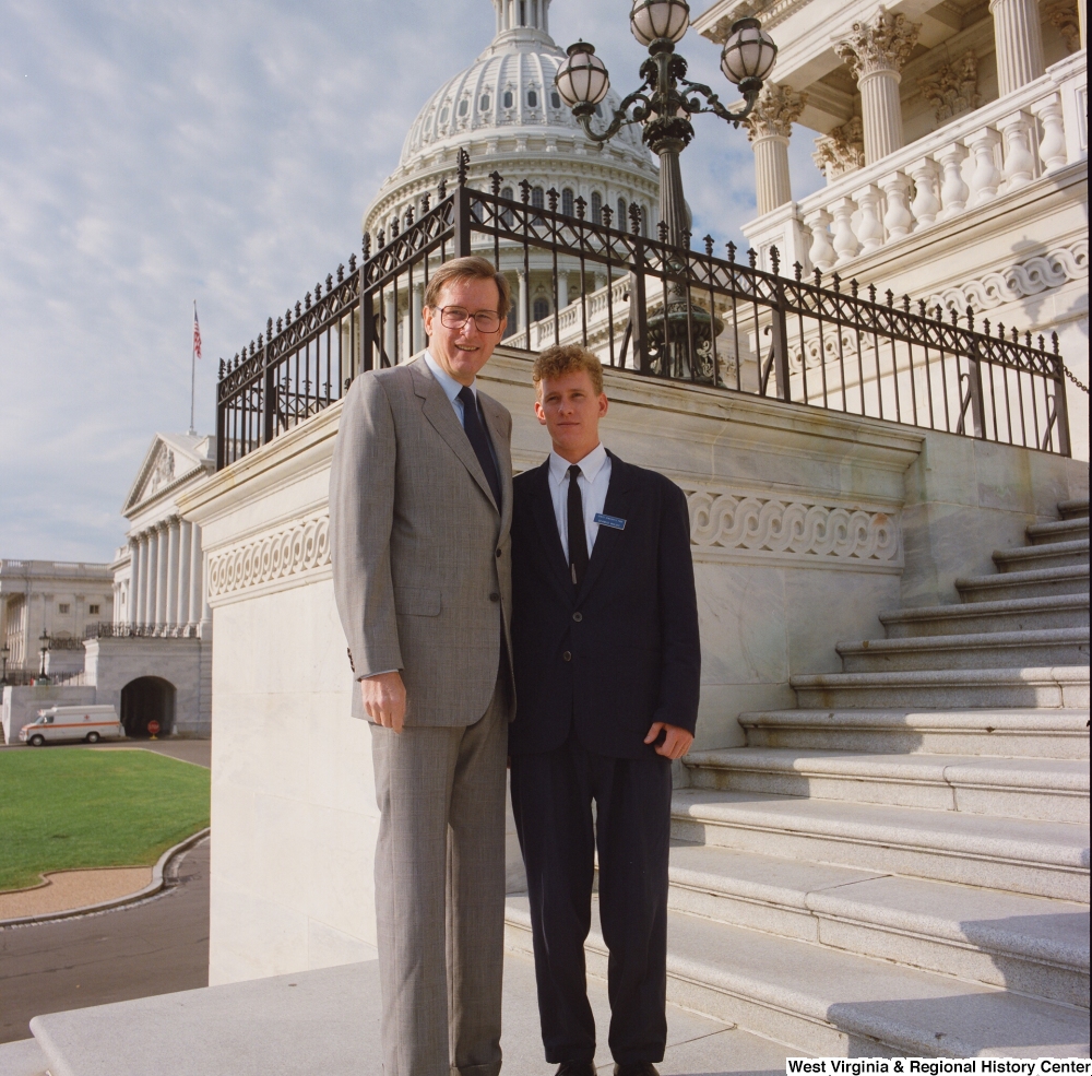 ["Senator John D. (Jay) Rockefeller stands next to a Senate Page on the steps to the Senate."]%