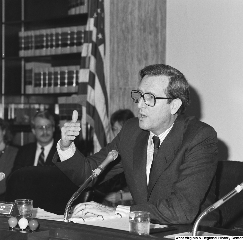 ["Senator John D. (Jay) Rockefeller gestures with his hand while speaking during a Senate committee hearing."]%