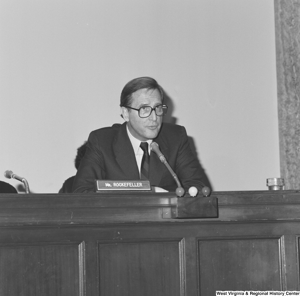 ["Senator John D. (Jay) Rockefeller sits behind the desk at a Senate committee hearing."]%