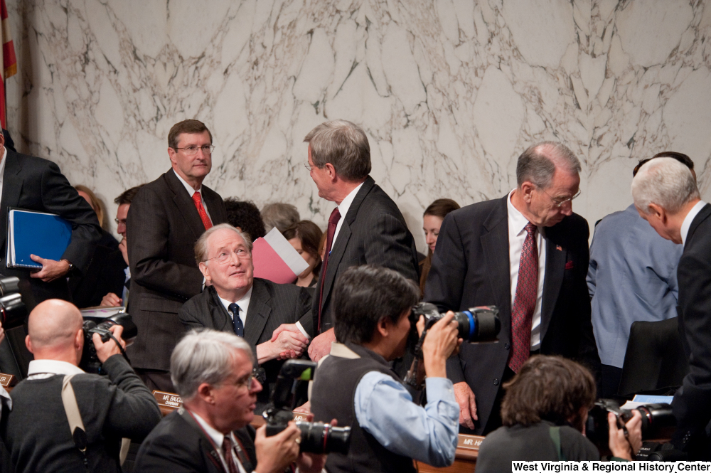 ["Senators John D. (Jay) Rockefeller and Max Baucus shake hands after a Finance Committee hearing."]%