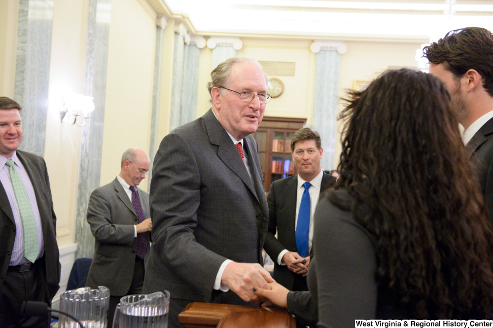 ["Senator John D. (Jay) Rockefeller shakes hands with a person after a Commerce Committee hearing on concussions and the marketing of sports equipment."]%