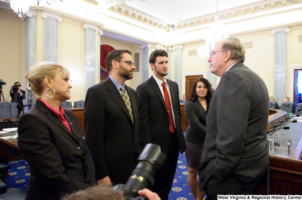 ["Senator John D. (Jay) Rockefeller speaks to unidentified individuals before a Commerce Committee hearing on concussions and sports equipment marketing."]%