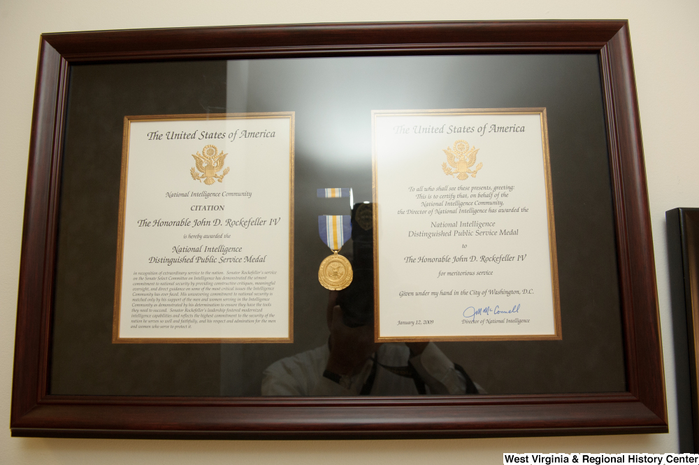 ["Senator John D. (Jay) Rockefeller's National Intelligence Distinguished Public Service Medal award hangs on a wall in his office."]%