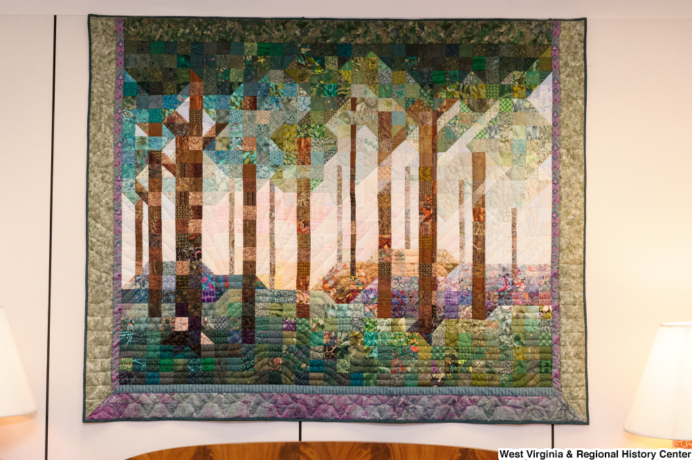 ["This photo shows a colorful forest quilt hanging in Senator John D. (Jay) Rockefeller's office."]%