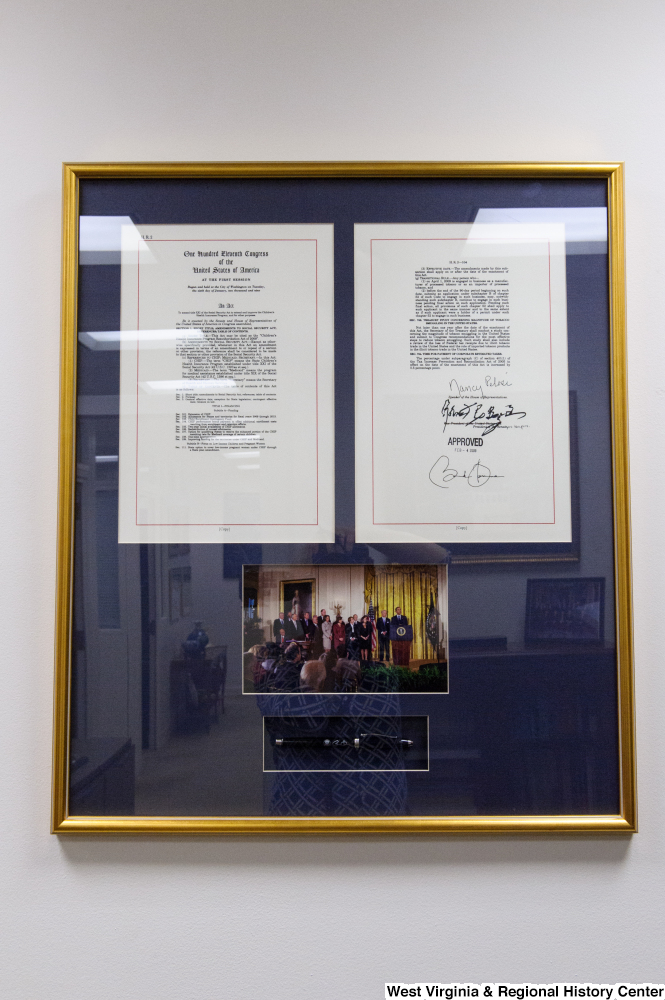 ["A signed copy of an act to reauthorize the Children's Health Insurance Program hangs in Senator John D. (Jay) Rockefeller's office."]%