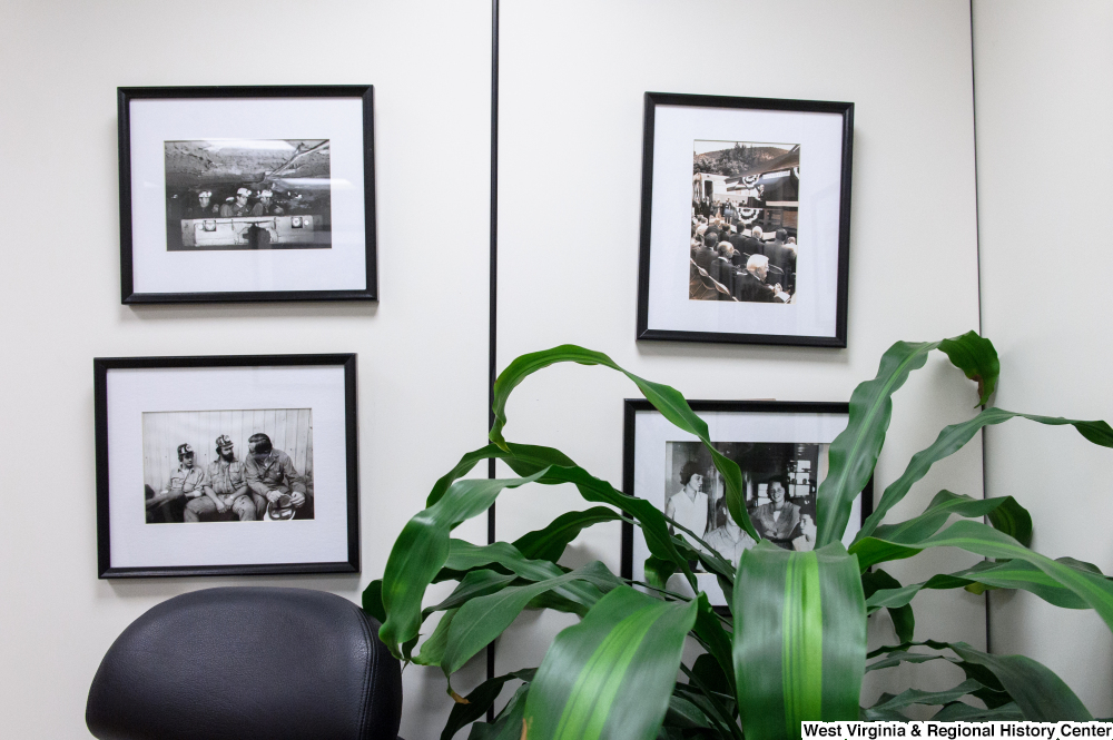 ["Several photographs of Senator John D. (Jay) Rockefeller hang on a wall in his office."]%
