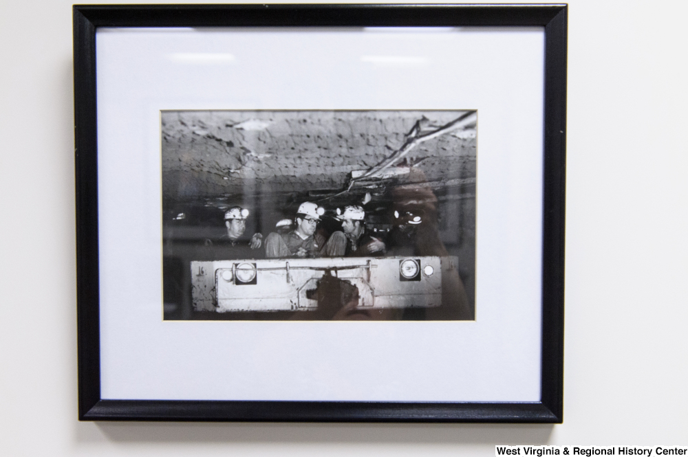 ["Senator John D. (Jay) Rockefeller sits in a coal car with some West Virginia miners."]%