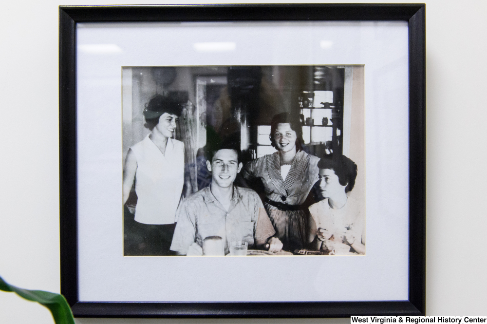 ["Photograph of a framed image of a young Jay Rockefeller."]%