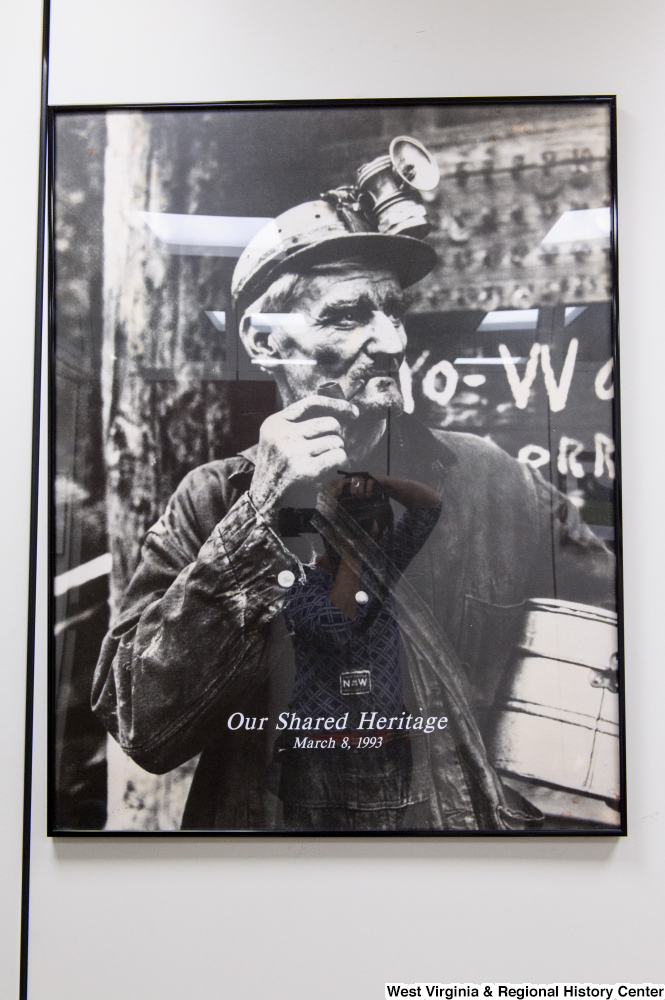 ["A photograph of a West Virginia coal miner hangs in Senator Rockefeller's office."]%