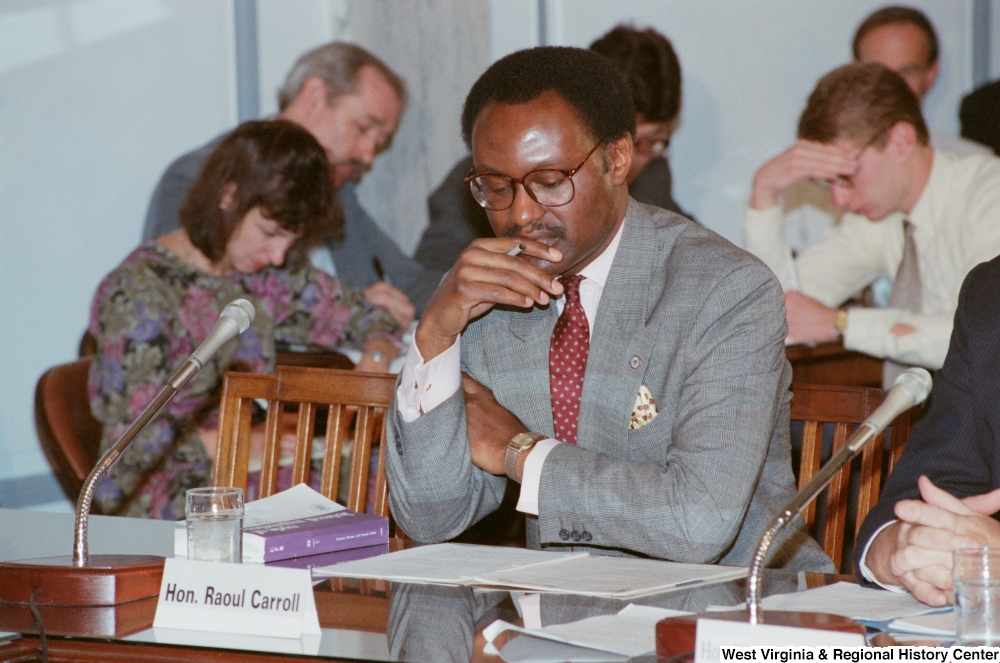 ["Raoul Carrol, nominated by President George Bush to serve as General Council for the Department of Veterans Affairs, sits at a Senate conference session."]%