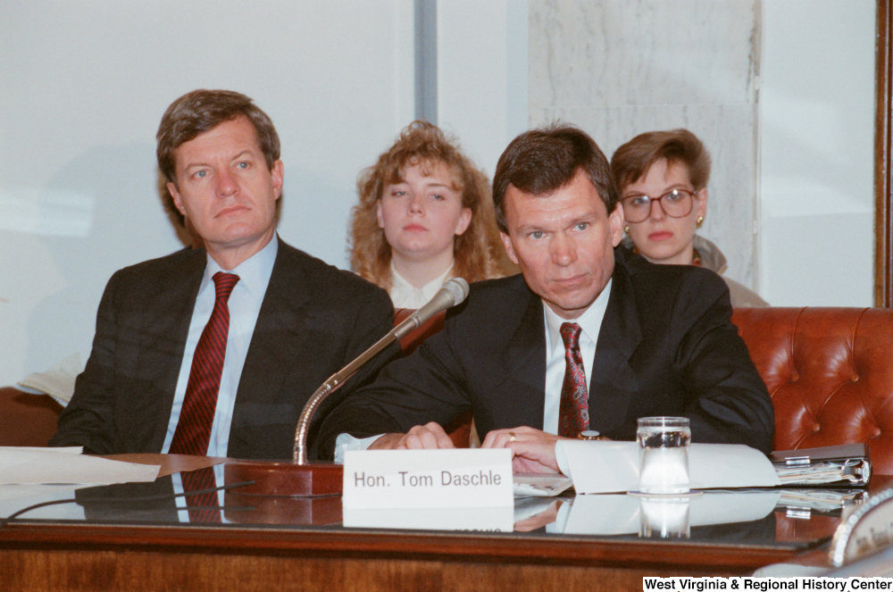 ["Senator Tom Daschle sits at a Senate conference event."]%