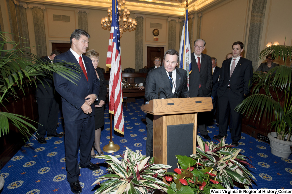 ["An unidentified man speaks at Senator Joe Manchin's swearing-in ceremony."]%