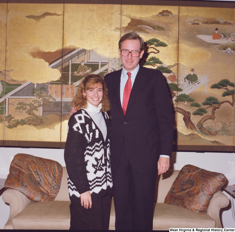 ["Senator John D. (Jay) Rockefeller stands next to an unidentified young woman in his office."]%