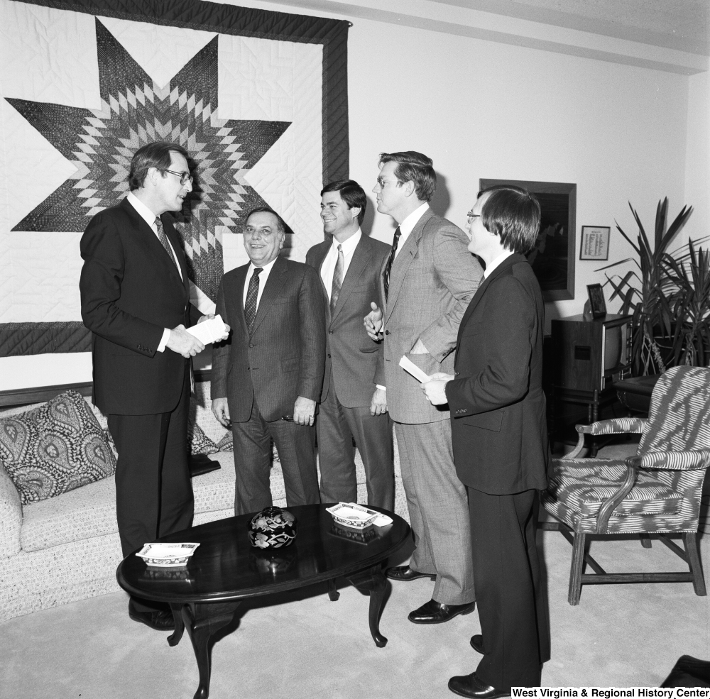 ["Senator John D. (Jay) Rockefeller meets with an unidentified group in his Washington office."]%